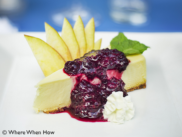 A photograph of Dessert of Vanilla Cheescake with Berry topping at Ocean Club Plaza, Providenciales (Provo), Turks and Caicos Islands.