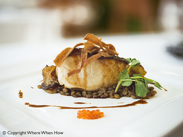 A photograph of Black Cod with Puy lentils at Parallel23, Providenciales (Provo), Turks and Caicos Islands.