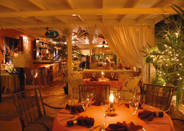 A photograph of the intimate garden terrace at Coyaba Restaurant, Grace Bay, Providenciales (Provo), Turks and Caicos Islands.