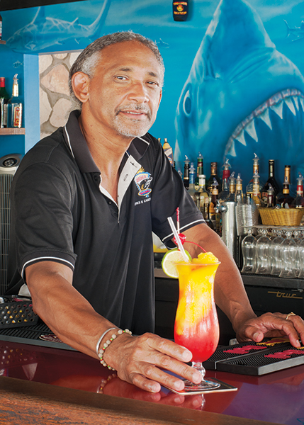 A photograph of Sharkbite Bartender Keith Hawkins is famous for his unique cocktails at Turtle Cove Marina, Turtle Cove, Providenciales (Provo), Turks and Caicos Islands.